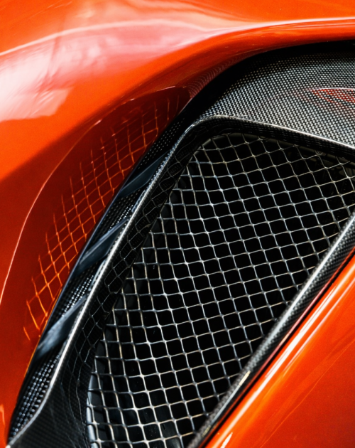 Glossy orange sports car air vent